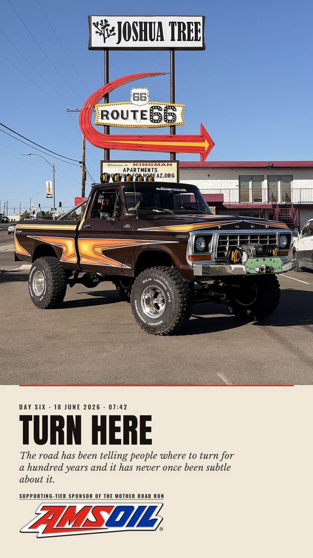 Designed sheet, Turn Here: Brownie in a Kingman lot beneath a tall neon Route 66 arrow sign and a Joshua Tree motel board, day six.