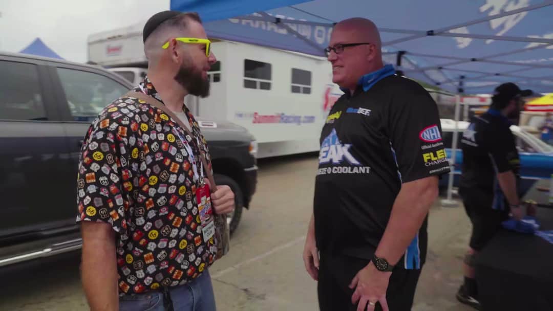 Solomon speaking with Brian Bolander in PEAK apparel beside the event paddock before the Route 66 shakedown cruise in Illinois.