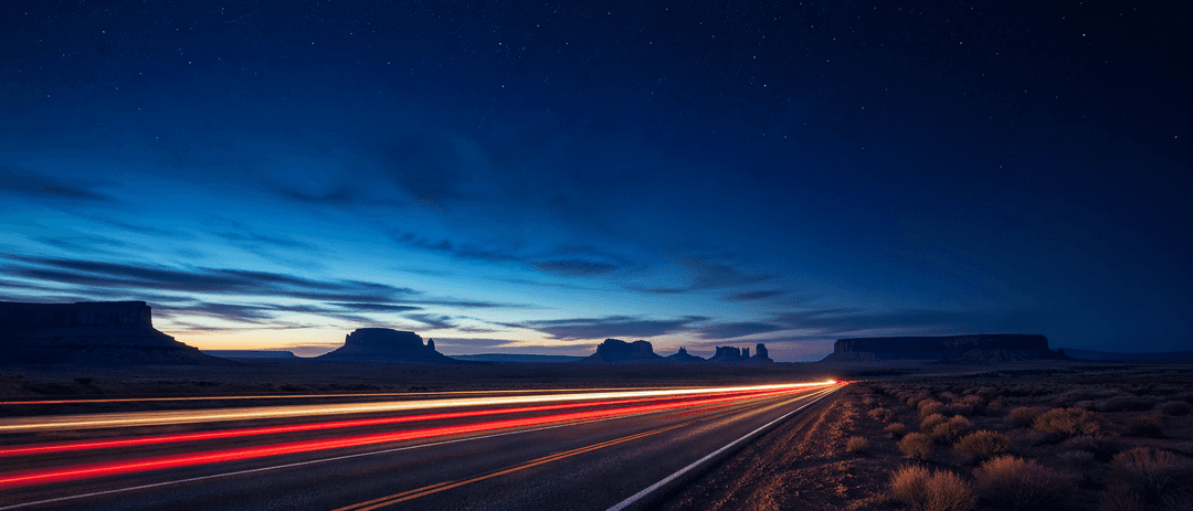 Night lights streaking across a dark desert highway