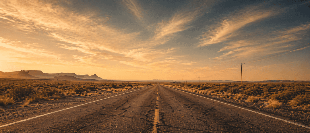 Route 66 stretching toward the horizon at golden hour